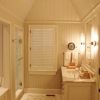 Bath with paneling and tall ceiling