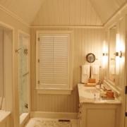 Bath with paneling and tall ceiling
