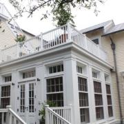 Exterior view of custom deck and floor to ceiling windows